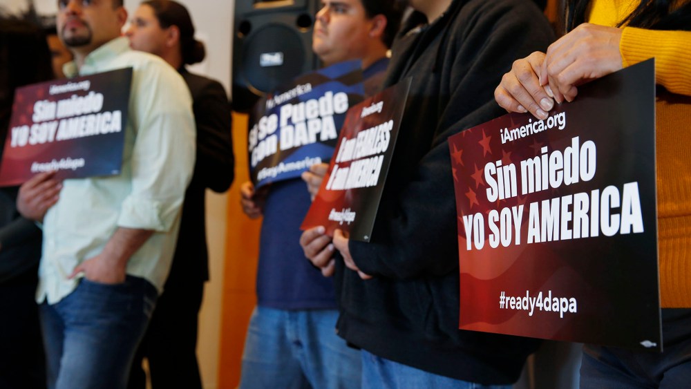 Supporters hold placards in support of immigration law changes during a news conference in the Denver Public Library, on Feb. 17, 2015, in Denver.