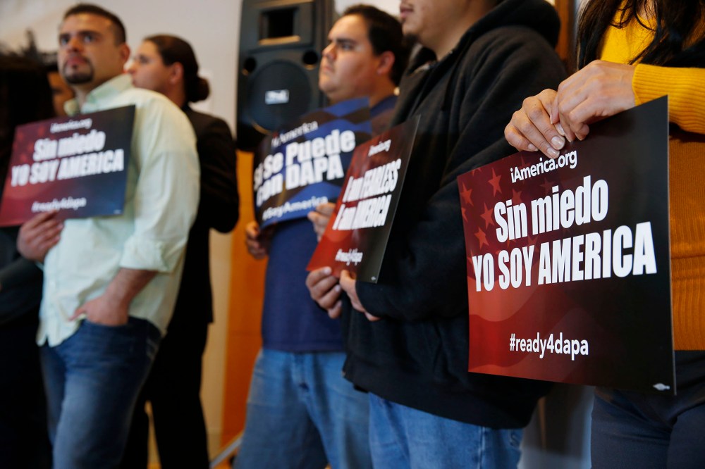Supporters hold placards in support of immigration law changes during a news conference in the Denver Public Library, on Feb. 17, 2015, in Denver.