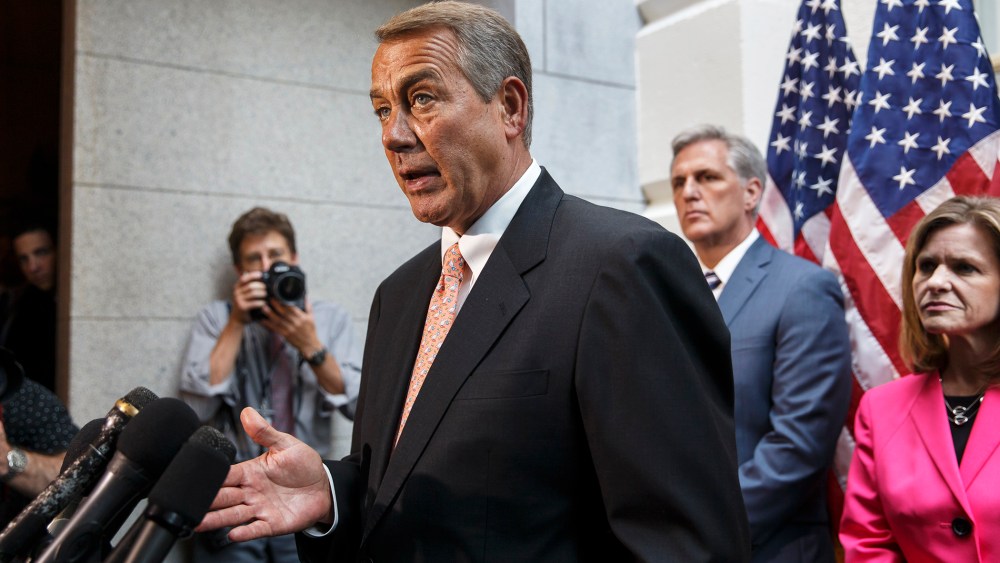 John Boehner talks with reporters on Capitol Hill in Washington, Wednesday, July 23, 2014, following a Republican strategy session.