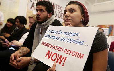 Undocumented immigrant Katherine Taberes, originally from Colombia, watches President Barack Obama's speech on immigration on January 29, 2013. (Photo by Mario Tama/Getty Images)
