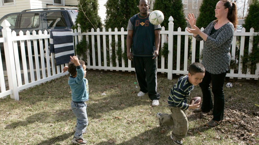 Michelle, right, and James Cadeau  with their children, Elliot, 2, left, and Justin, 5, play ball in the backyard of their home in West Orange, N.J., Friday, March 30, 2007. The surge of interracial marriages and multiracial children is producing a...