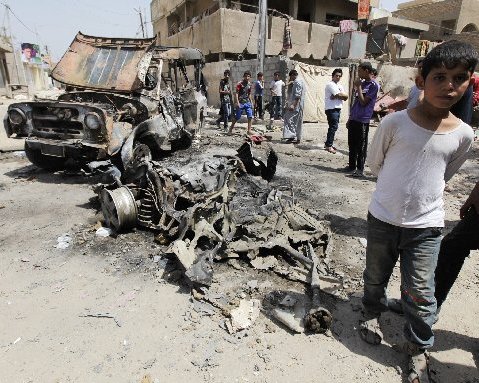 Residents gather at the site of a car bomb attack in the Kamaliya district in Baghdad April 15, 2013. Car bombs and attacks on cities across Iraq, including two blasts at a checkpoint at Baghdad international airport, killed at least 20 people and...