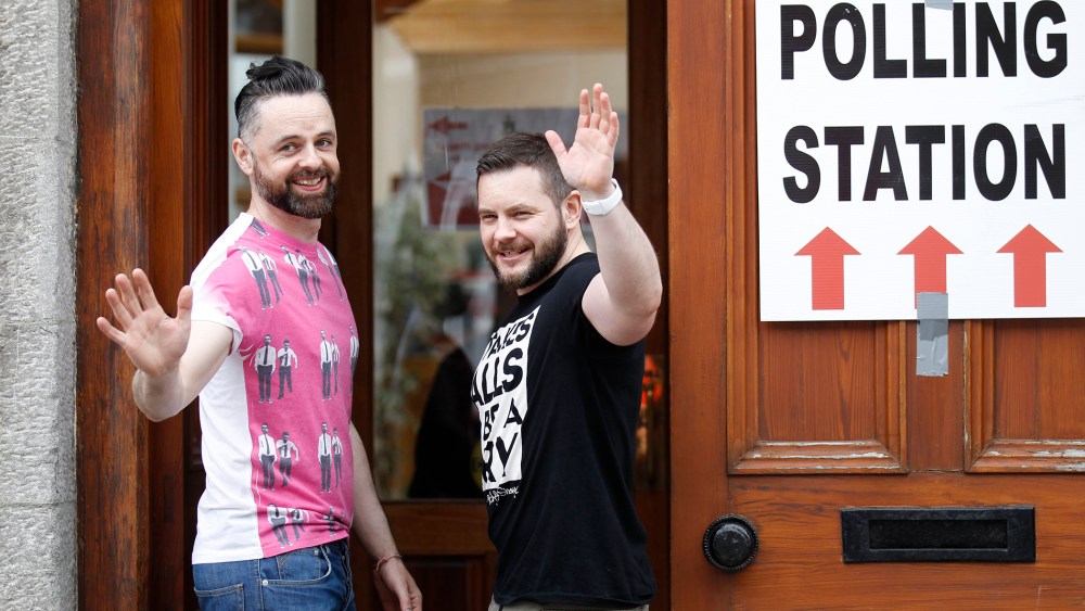 Partners Adrian, left and Shane, arrive to vote at a polling station in Drogheda, Ireland, Friday, May 22, 2015. (Photo by Peter Morrison/AP)