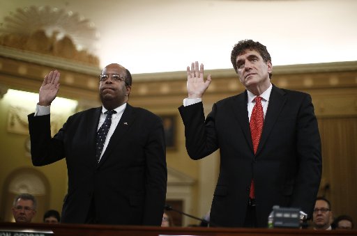 Outgoing acting IRS Commissioner Steven Miller (R) and Treasury Inspector General for Tax Administration (L). Russell George are sworn-in during a House Ways and Means Committee hearing on the Internal Revenue Service targeting conservative groups on...