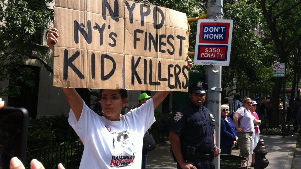 In front of an officer, a protester voices her displeasure with the New York Police Department during a June silent march down New York's Fifth Avenue.