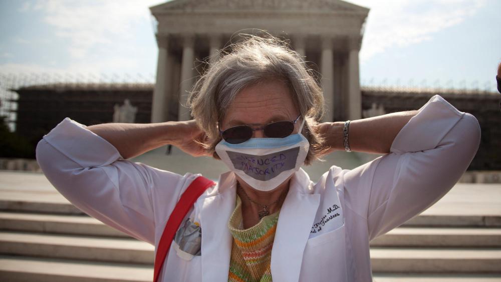 A demonstrator outside of the Supreme Court this morning.