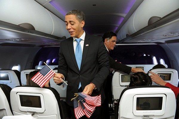 Presidential impersonators Reggie Brown and Jim Gossett and President Obama work both sides of the aisle, encouraging passengers to register to vote via the airline's in-flight entertainment screens.