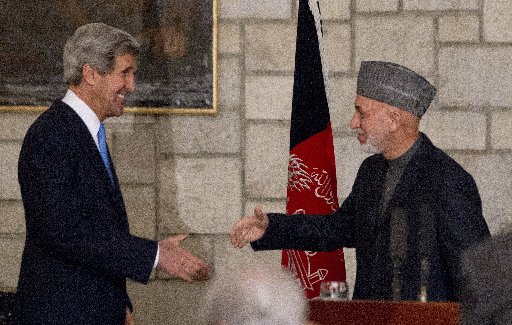US Secretary of State John Kerry and Afghanistan's President Hamid Karzai shake hands at the end of their press conference at the Presidential Palace in Kabul, on March 25, 2013. Kerry scrapped a planned visit to Pakistan to avoid accusations of...