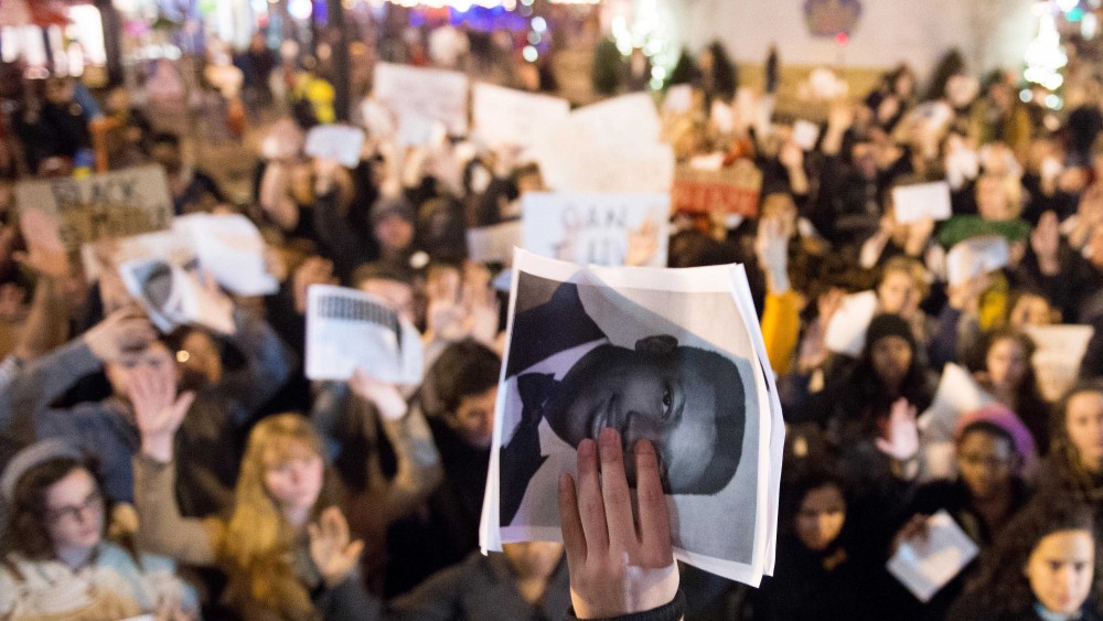 A photograph of Eric Garner is held up before a gathering of approximately 300 people in Knoxville, Tenn. for a demonstration against police brutality on Dec. 5, 2014. (Saul Young/The Knoxville News Sentinel/AP)
