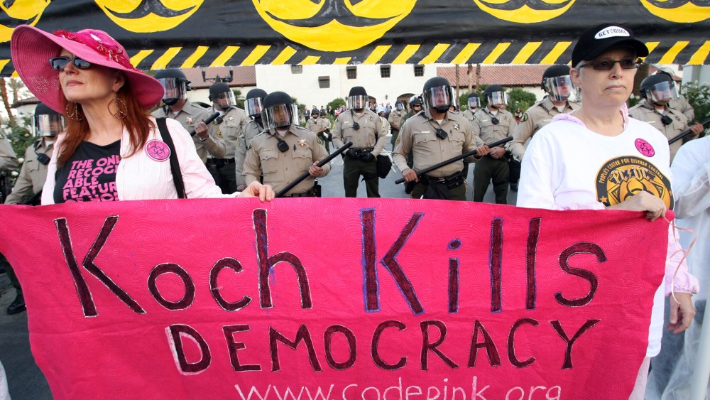 Riverside County Sheriff's deputies in riot gear are seen during a protest dubbed the "Koch Busters Rally" on Sunday, Jan. 30, 2011, in Rancho Mirage, Calif.