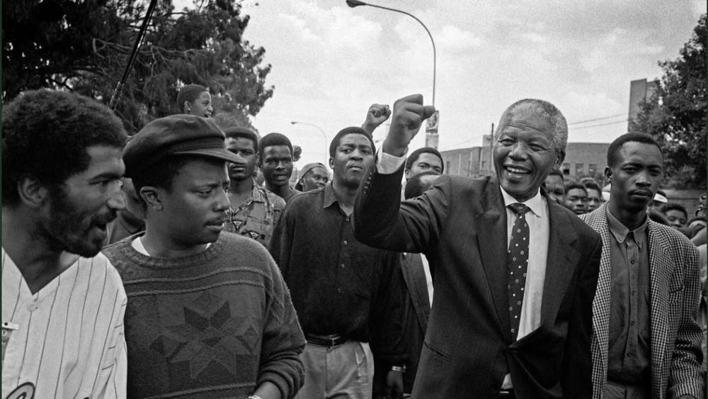 Nelson Mandela surprises locals on an impromptu walkabout in South Africa, 1994.