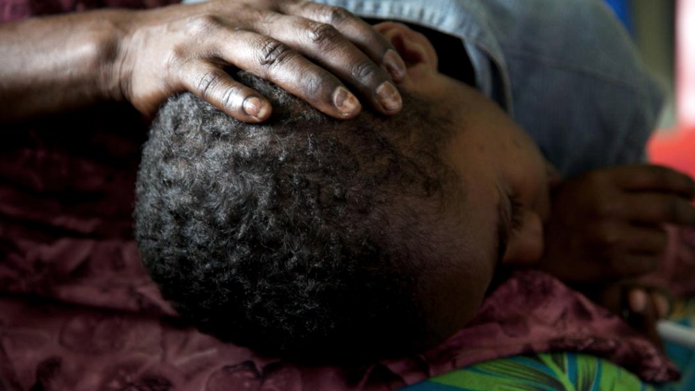 Selina Clement holds her 7-year-old son Emanuel at an HIV drop in center in Port Moresby, Papua New Guinea. Both are HIV positive.