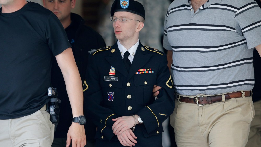 Army Pfc. Bradley Manning, center, is escorted out of a courthouse in Fort Meade, Md., Monday, June 17, 2013, after the start of the third week of his court martial. (AP Photo/Patrick Semansky)
