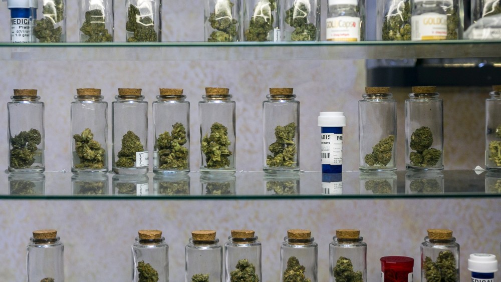 In this photo taken Tuesday, May 14, 2013, Medical marijuana vials are displayed at the Venice Beach Care Center medical marijuana dispensary in Venice, Calif.  (AP Photo/Damian Dovarganes)