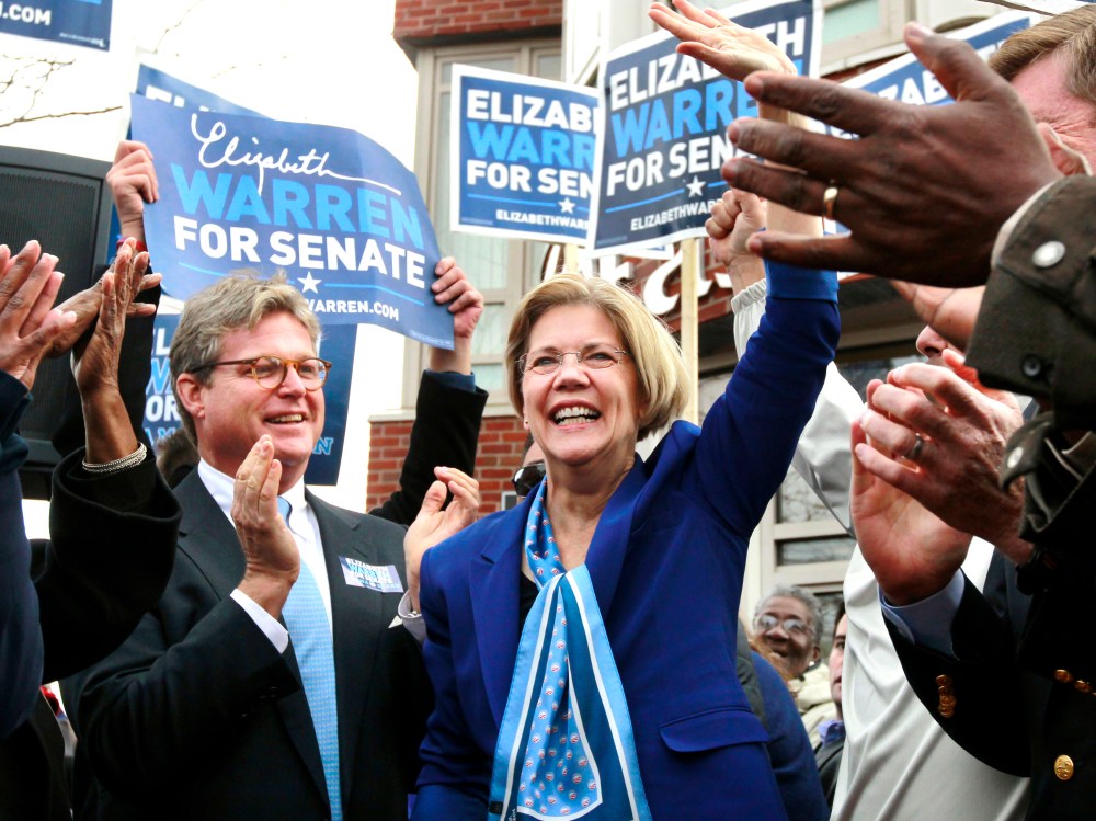 Democratic  U.S. Senate-elect Elizabeth Warren, center, waves to the crowd as Edward M. Kennedy, Jr., left, son of the late U.S. Sen. Edward M. Kennedy, D-Mass., applauds during a campaign stop in the Dorchester neighborhood of Boston, on Monday. ...