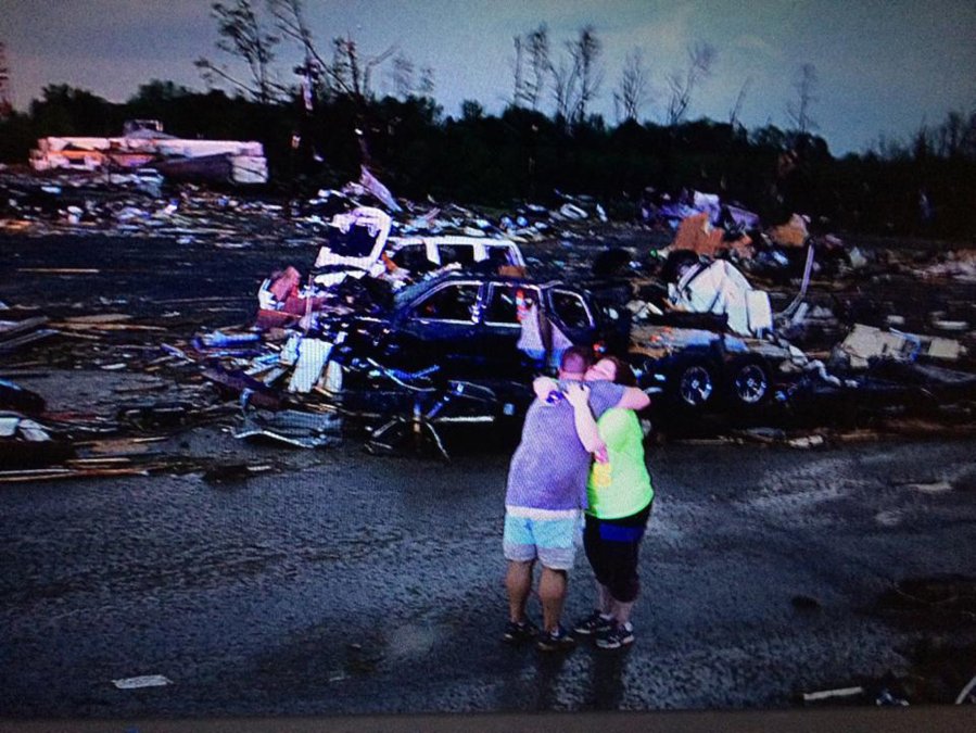 Image: Lori Berseth is consoled after searching for her missing black labrador dog Lucille after a tornado destroyed the town of Mayflower
