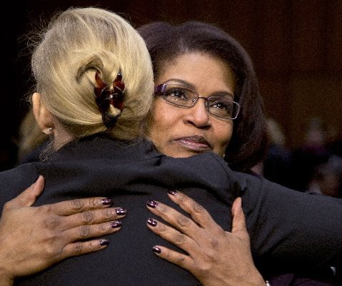 Senate subcommittee on Personnel Chair Sen. Kirsten Gillibrand, D-N.Y., left, hugs BriGette McCoy, a former Specialist in the U.S. Army, after McCoy testified on Capitol Hill in Washington, Wednesday, March 13, 2013, before the subcommittee's hearing...