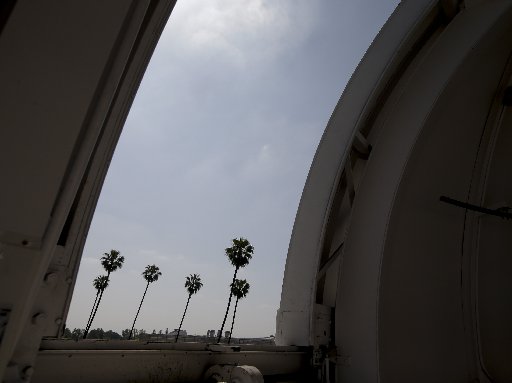 Palm trees are seen through an observatory door at Caltech's Linde + Robinson Laboratory in Pasadena, Calif., Friday, April 12, 2013. A mile above this city, sensors gaze down on the basin from atop Mount Wilson the way a satellite fixates on Earth,...