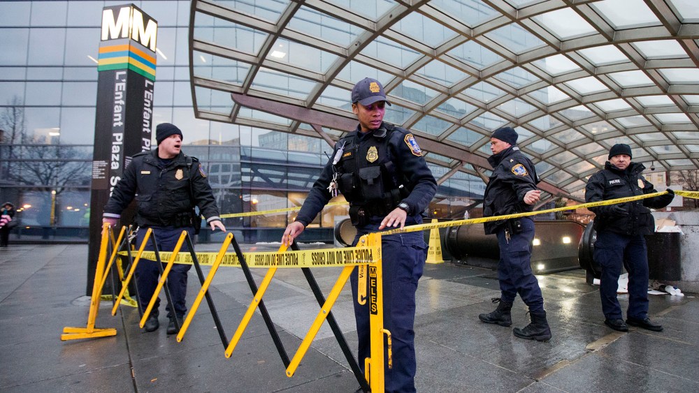 Metro Transit Police officers, secure the entrance to L'­Enfant Plaza Station in Washington, D.C., Jan. 12, 2015. (Photo by Manuel Balce Ceneta/AP)