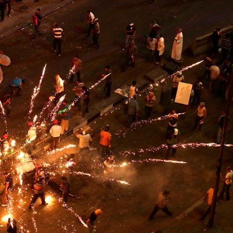 Supporters and opponents of Egypt's ousted President Mohammed Morsi clash near Maspero, Egypt's state TV and radio station is located, in Cairo, Egypt, Friday, July 5, 2013. (Photo by Hassan Ammar/AP)