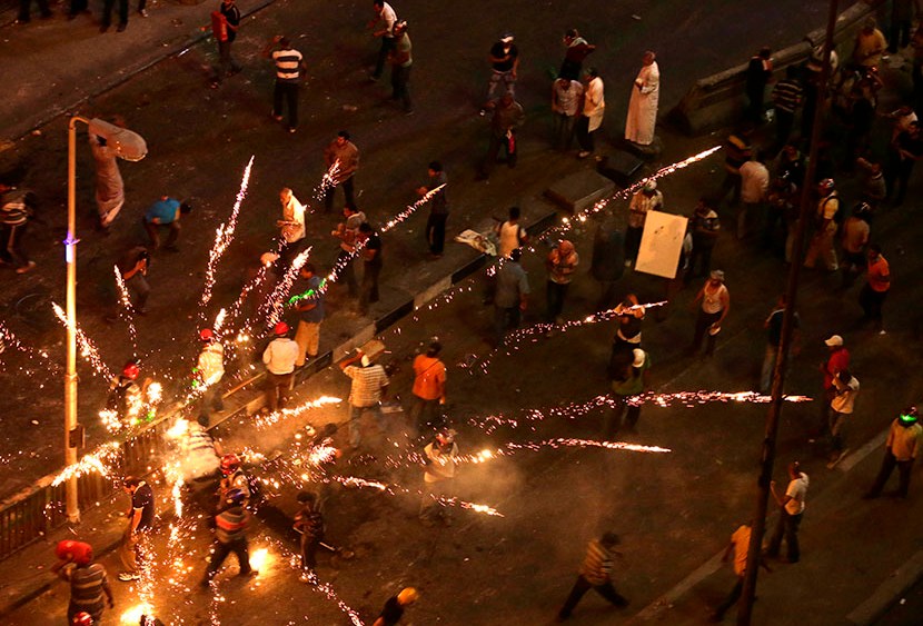 Supporters and opponents of Egypt's ousted President Mohammed Morsi clash near Maspero, Egypt's state TV and radio station is located, in Cairo, Egypt, Friday, July 5, 2013. (Photo by Hassan Ammar/AP)