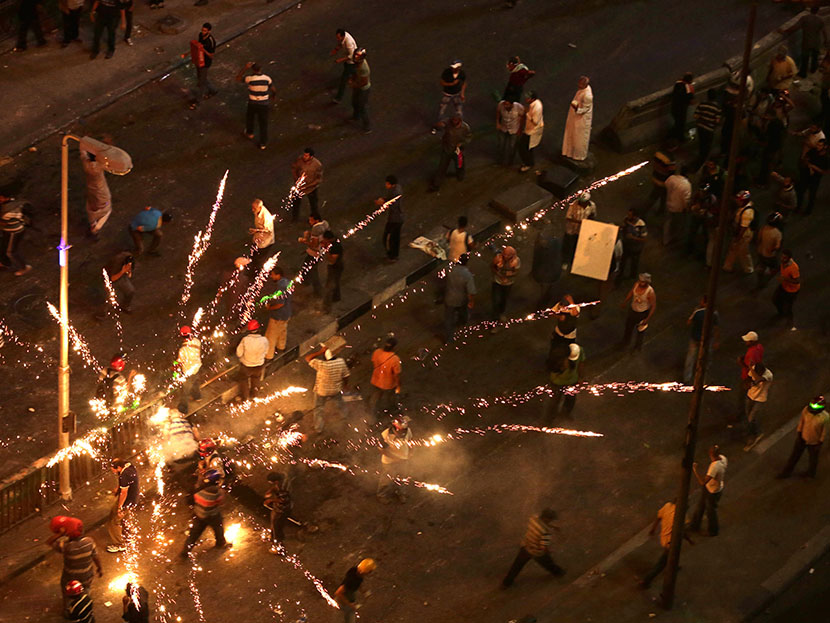 Supporters and opponents of Egypt's ousted President Mohammed Morsi clash near Maspero, Egypt's state TV and radio station is located, in Cairo, Egypt, Friday, July 5, 2013. (Photo by Hassan Ammar/AP)