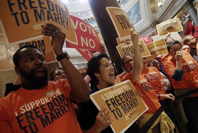 Demonstrators gather outside the Minnesota House chamber as they take up the gay marriage bill at the State Capitol, May 9, 2013 in St. Paul, Minn. (Photo by Jim Mone/AP)