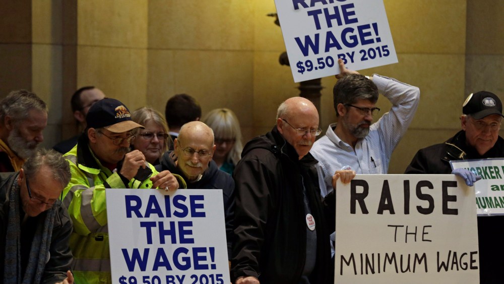 Demonstrators rally at the state Capitol, calling for lawmakers to raise the minimum wage, February 25, 2014, in St. Paul, Minn.
