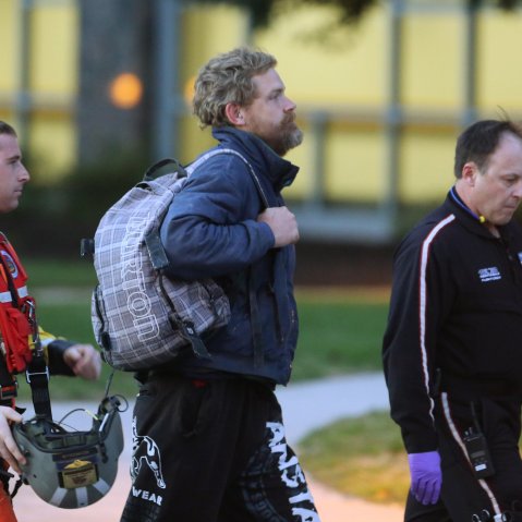 Louis Jordan, center, walks from the Coast Guard helicopter to the Sentara Norfolk General Hospital in Norfolk, Va., after being found off the North Carolina coast, on April 2, 2015. (Photo by Steve Earley/The Virginian-Pilot/AP)