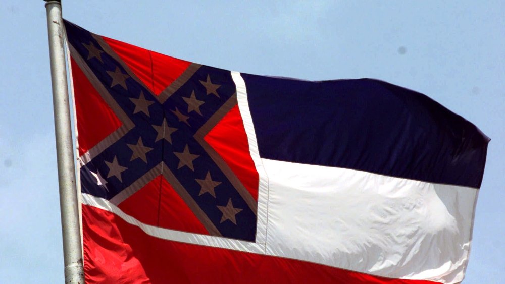The Mississippi flag, photographed at the Capitol in Jackson, has been compared to a "badge of slavery," by civil rights groups.  (Photo by Rogelio Solis/AP)