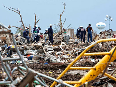 Rescue workers look through the rubble at Plaza Towers Elementary school in Moore, Oklahoma May 21, 2013 after a devastating tornado ripped through the town. (Photo by Richard Rowe/Reuters)