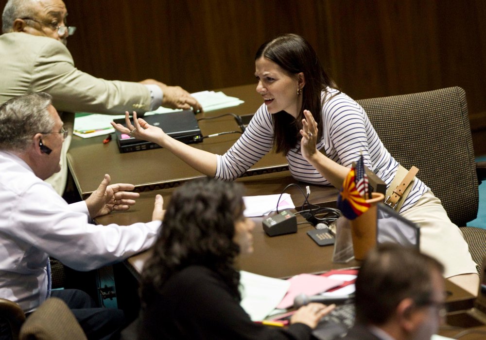 Arizona State Rep. Michelle Ugenti, R- Scottsdale, speaks with Arizona Rep, Russ Jones, R-Yuma, during a legislative session Wednesday, April 6, 2011 at the Capitol in Phoenix. The Arizona Legislature, now pushing to ends its 2011 regular session, is...