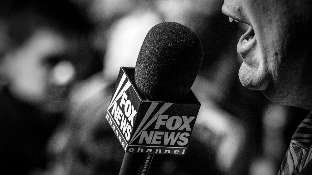 A Fox News reporter works from the Bernie Sanders rally in Iowa City, Ia., Jan. 30, 2016. (Photo by Mark Peterson/Redux for MSNBC)