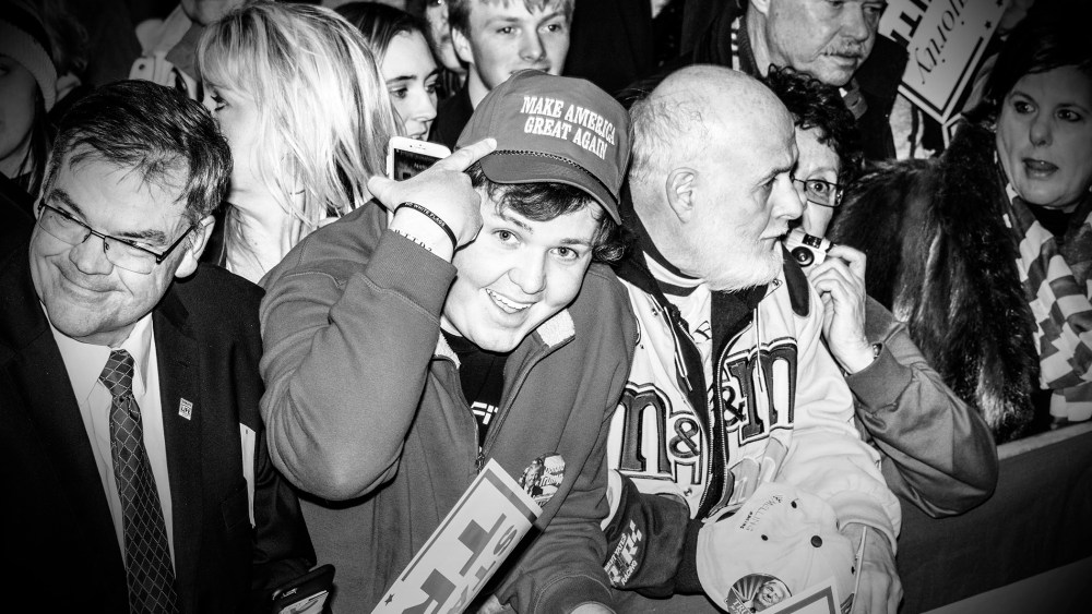 A supporter of Republican presidential candidate Donald Trump points to his hat at a rally in Marshalltown, Iowa, Jan. 26, 2016. (Photo by Mark Peterson/Redux for MSNBC)