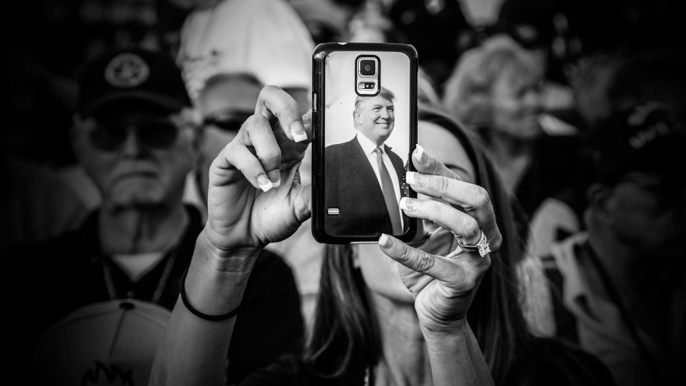 A Donald Trump supporter uses her phone as the billionaire arrived at his "Make America's Military Great Again" rally, held aboard the retired USS Iowa battleship, in Los Angeles, Calif., Sept. 15, 2015. (Photo by Mark Peterson/Redux for MSNBC)