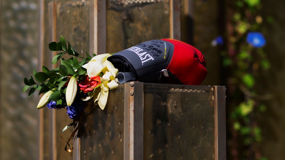 Flowers and a boxing glove are left at a makeshift memorial to Muhammad Ali at the Muhammad Ali Center, June 6, 2016, in Louisville, Ky. (Photo by David Goldman/AP)