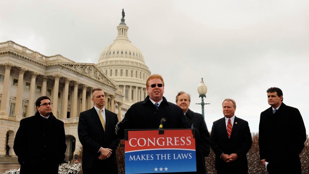 Dr. Larry Kawa, center, speaks about his lawsuit against the IRS regarding the employer mandate in the Affordable Care Act.