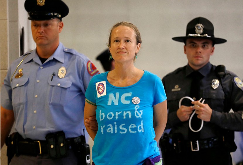 A woman is arrested outside the House and Senate chambers during "Moral Monday" protests at the General Assembly in Raleigh, N.C., Monday, June 24, 2013. (Photo by Gerry Broome/AP)