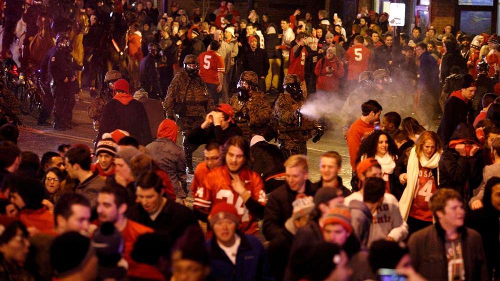 Police officers try to disperse the crowd of Ohio State fans blocking High Street in Columbus, Ohio, as they celebrate the Buckeye's 42-20 National Championship football game win over Oregon outside of campus on Jan. 12, 2015.