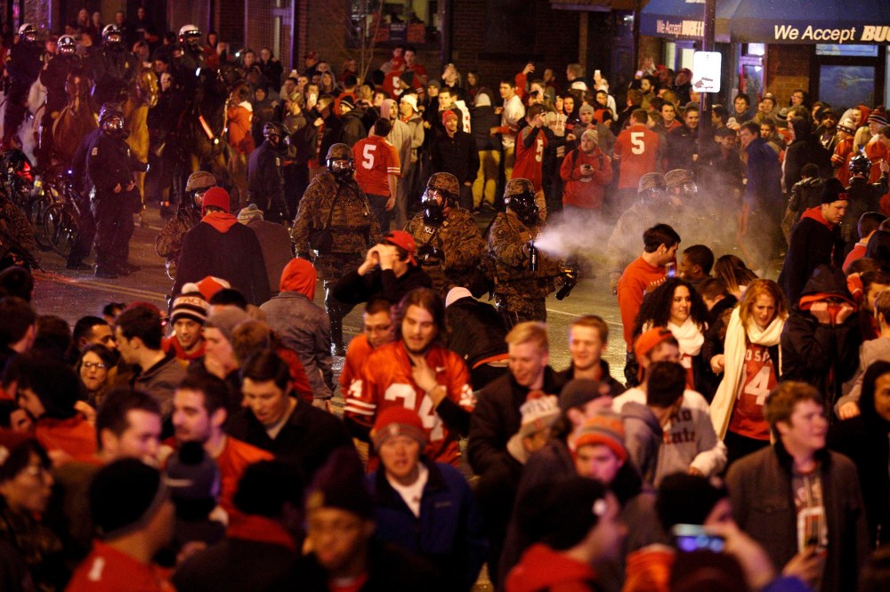 Police officers try to disperse the crowd of Ohio State fans blocking High Street in Columbus, Ohio, as they celebrate the Buckeye's 42-20 National Championship football game win over Oregon outside of campus on Jan. 12, 2015.