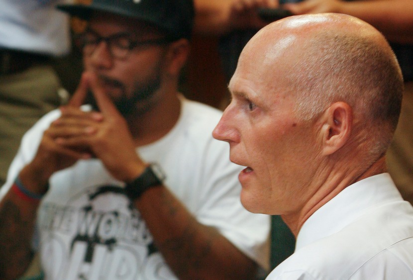 Florida Gov. Rick Scott speaks to protestors Thursday July 18, 2013 in the Capitol in Tallahassee, Fla. Florida Gov. Rick Scott is telling protesters that he will not ask lawmakers to revamp the state's self-defense laws. (Photo by Phil Sears/AP)