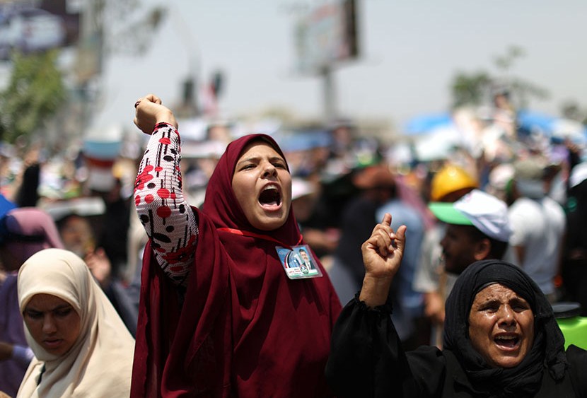 Supporters of deposed Egyptian president Mohamed Morsi shout slogans during a rally in support of the former Islamist leader outside Cairo's Rabaa al-Adawiya mosque on July 9, 2013.  (Photo by Mahmud Hamsmahmud Hams/AFP/Getty Images)