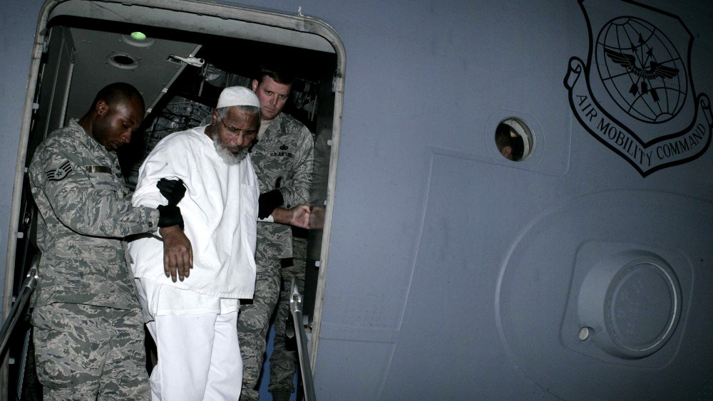 US soldiers help Sudanese Guantanamo prisoner Ibrahim Othman Ibrahim Idris exit a US military plane at Khartoum airport following his release from the Cuba-based US prison on Dec. 19, 2013.