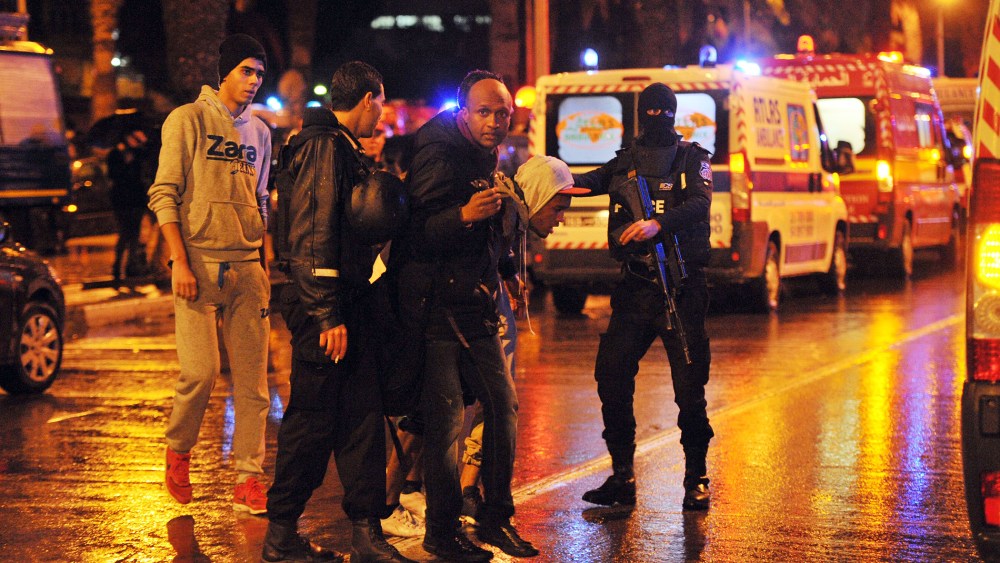 Family members of victims of a bomb blast on a bus transporting Tunisia's presidential guard in central Tunis react at the site of the attack on Nov. 24, 2015. (Photo by Fethi Belaid/AFP/Getty)