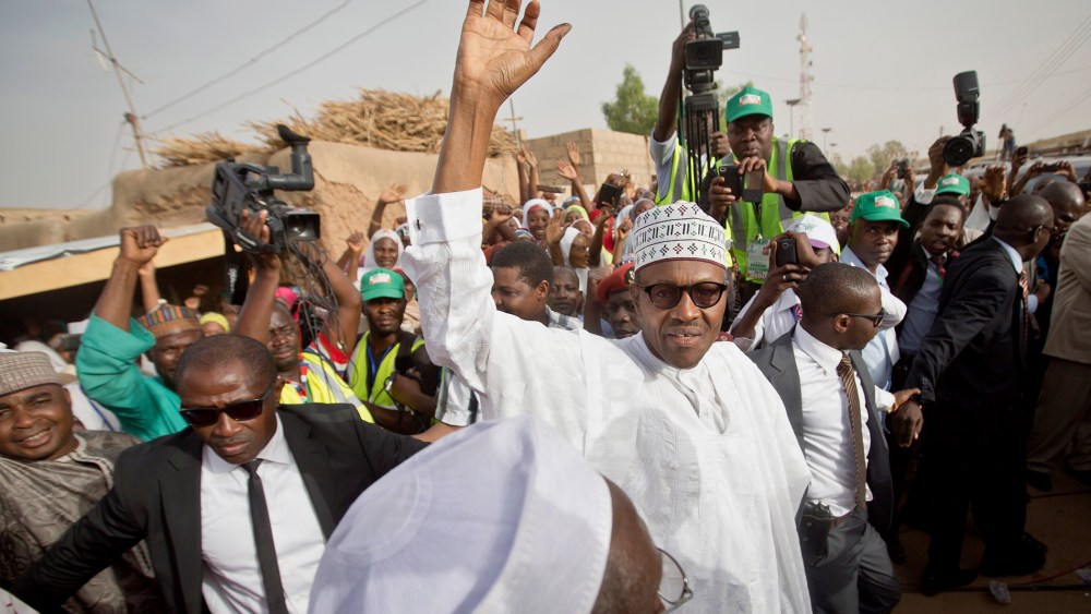Gen. Muhammadu Buhari waves to supporters after casting his vote in his home town of Daura, northern Nigeria on March 28, 2015. (Photo by Ben Curtis/AP)