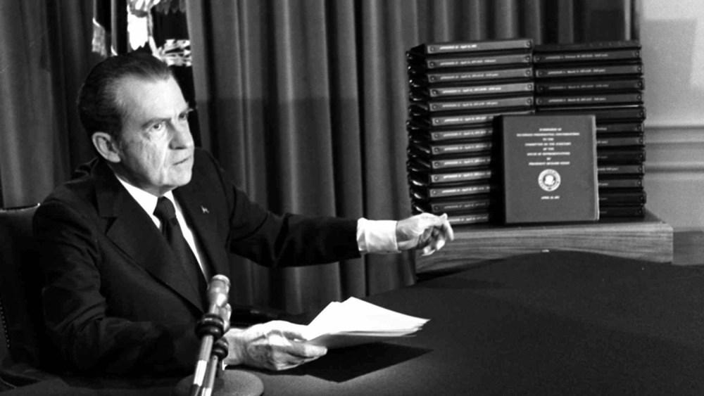 President Richard Nixon gestures toward transcripts of White House tapes after announcing he would turn them over to House impeachment investigators and make them public in April of 1974. (AP Photo)
