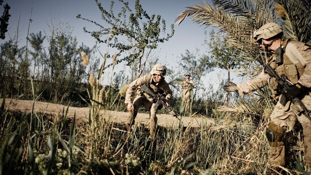 US Marines from Alpha Co. 1-6th Marines Lance Cpl Brendan Hart (right), extends a hand to Lance Cpl Charles Dawe on March 24, 2010 in Afghanistan.