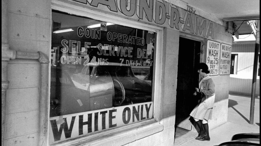 A woman entering a segregated laundromat in Louisiana, New Orleans, 1963.