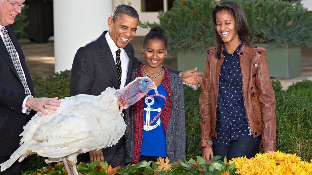 President Barack Obama, with daughters Sasha, center, and Malia, right, carries on the Thanksgiving tradition of saving a turkey from the dinner table with a "presidential pardon," at the White House in Washington, Wednesday, Nov. 21, 2012.  After the...
