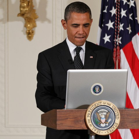 President Barack Obama uses a laptop computer to send a tweet during a "Twitter Town Hall" in the East Room of the White House in Washington, Wednesday, July 6, 2011.
